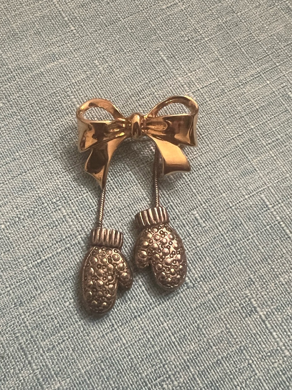 Gold and silver tone ribbon and mittens pin brooch